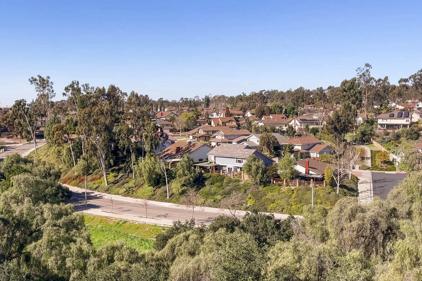 Older Fullerton home with a narrow laundry closet housing a stacked washer and dryer set