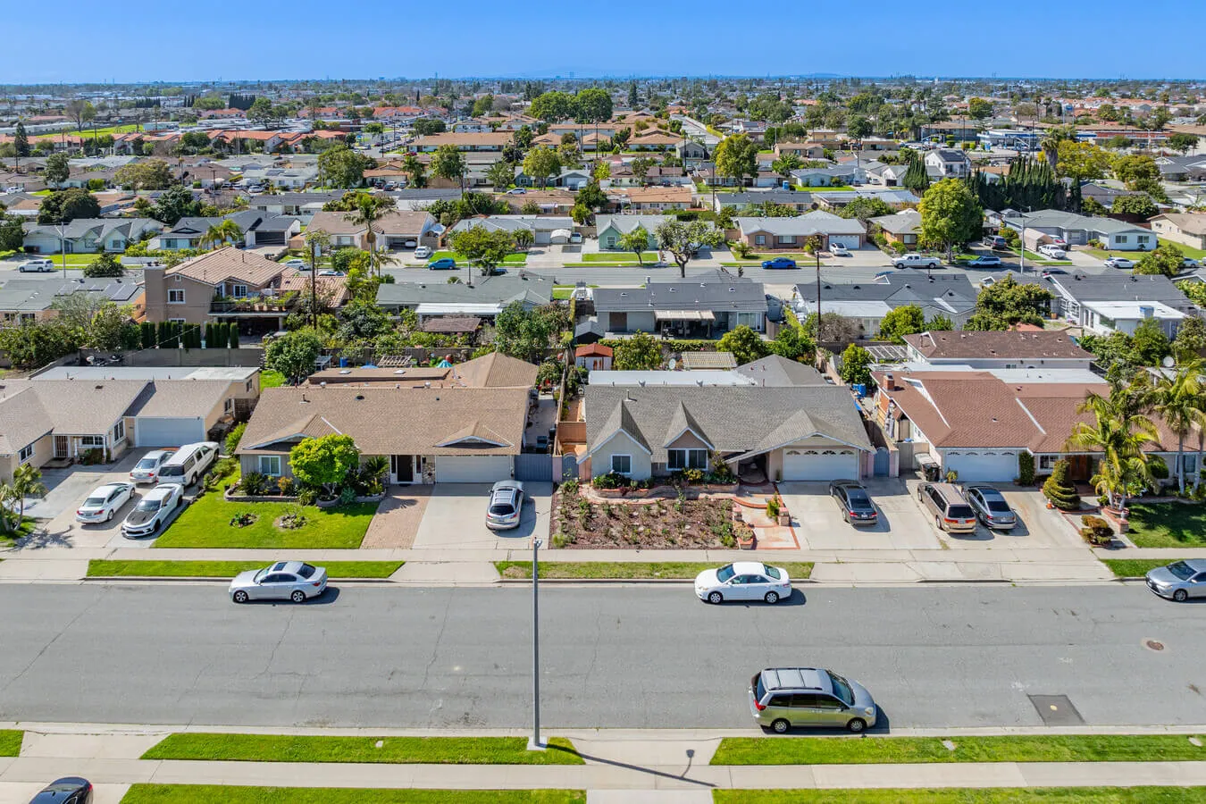 Garden Grove single-family home with a side-yard laundry area visible through an open garage